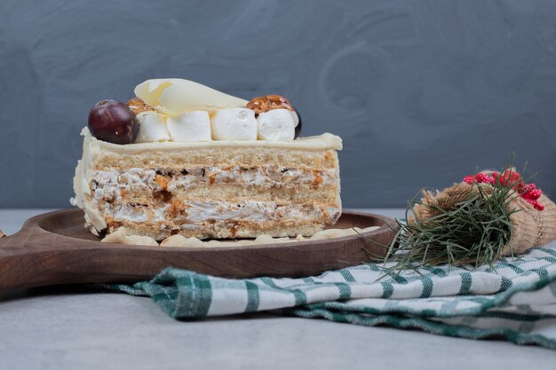White chocolate cake on wooden board with Christmas decorations. High quality photo