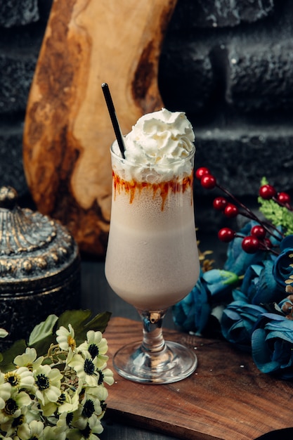 white chocolate mocha in glass with whipped cream and straw