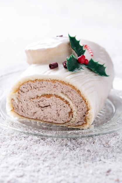 White chocolate yule log cake with ornament