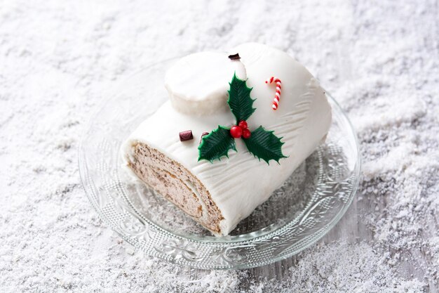 White chocolate yule log cake with ornament