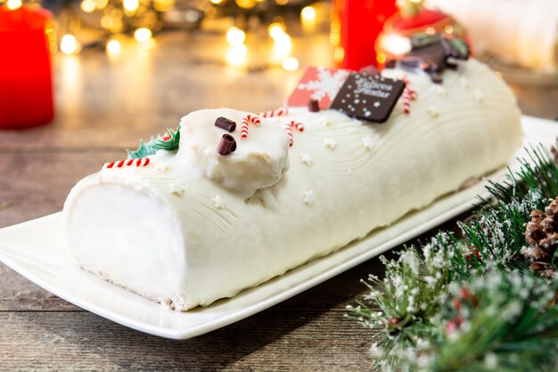 장식이 있는 화이트 초콜릿 성탄절 통나무 케이크