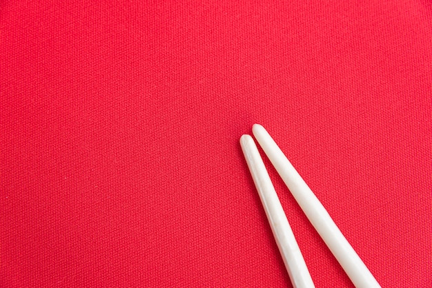 White chopsticks on the red table