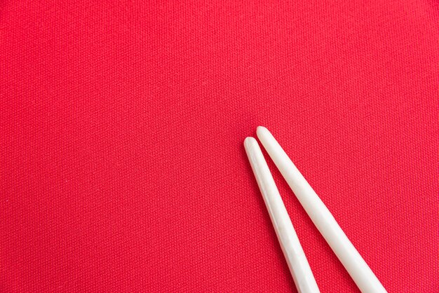 White chopsticks on the red table