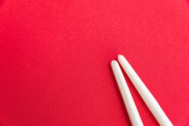 White chopsticks on the red table