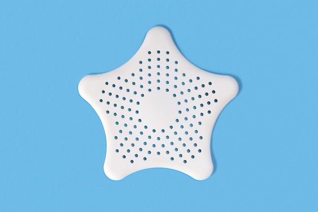 White clean silicone star for kitchen sink or bathroom filter, close-up on blue background