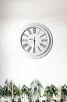 Free photo white clock on a white wall in the interior