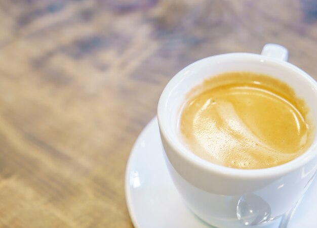 カフェでテーブルの上に白いコーヒーカップ