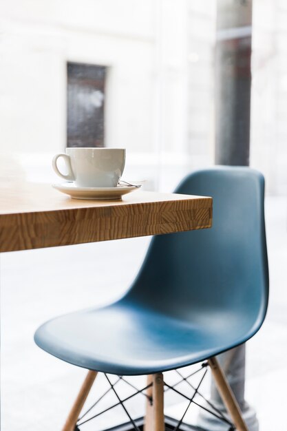 White coffee cup on wooden desk in caf� shop