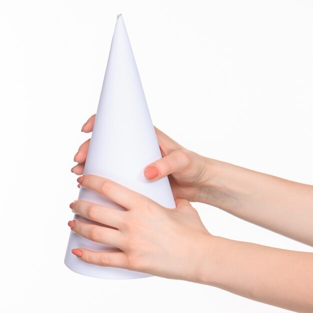 The white cone of the props in the female hands on white with  right shadow