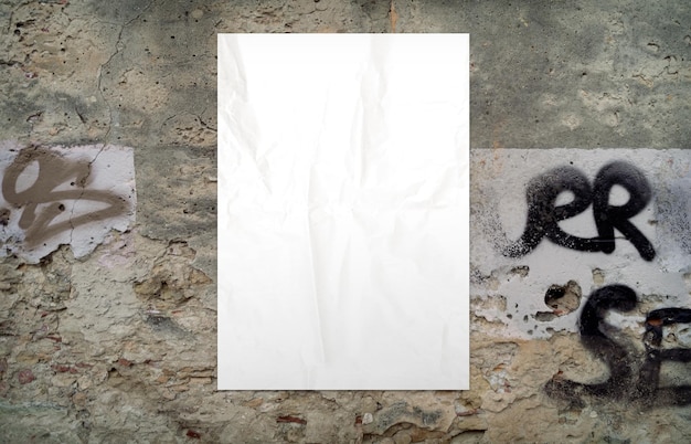 Free photo white crumpled poster on an old grunge wall