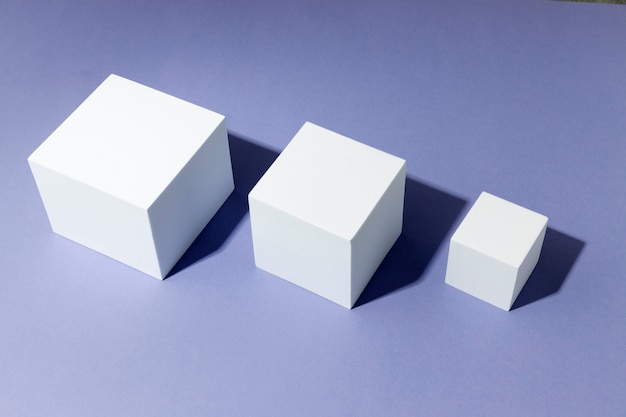 Free photo white cubes assorment on purple background