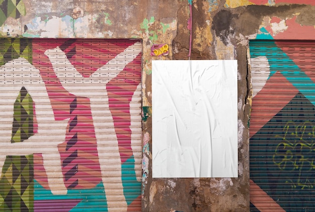 White cumpled poster on grunge graffiti wall