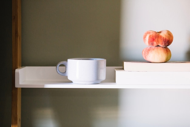 Free Photo white cup and peaches