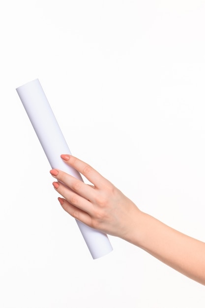 white cylinder of the props in the female hands on white background