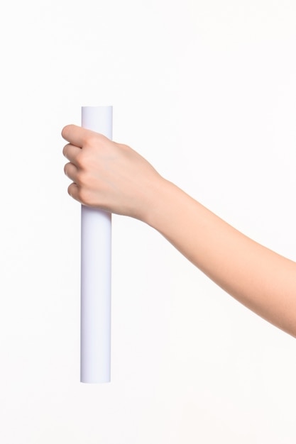 The white cylinder of the props in the female hands on white