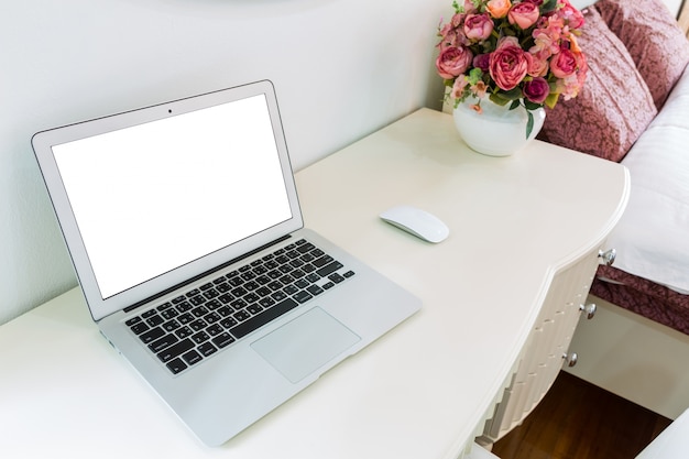 White desk with laptop and mouse