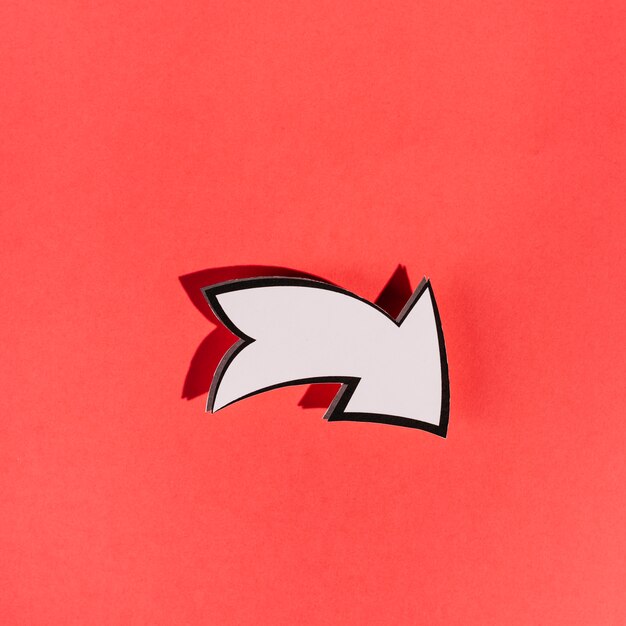 White directional arrow on red background