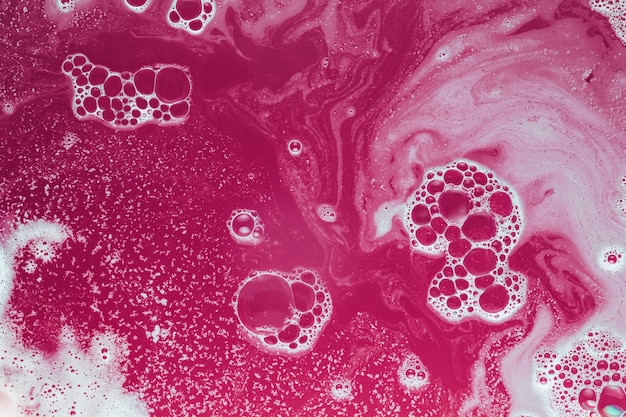 White dye and bubbles on fuchsia water