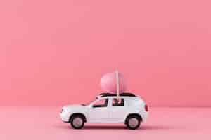 Free photo white easter car with pink egg and background