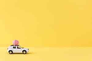 Free photo white easter car with pink egg and copy space