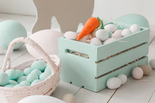 White easter eggs in painted wooden box.