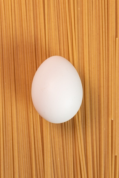 White egg on the raw pasta