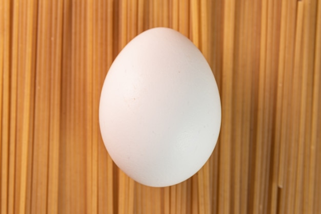 Free photo white egg on the raw pasta