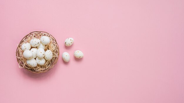 White eggs in nest on table