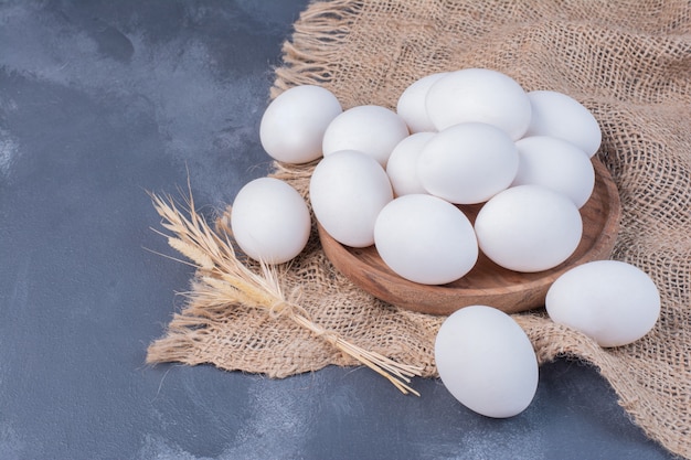 White eggs on piece of burlap.