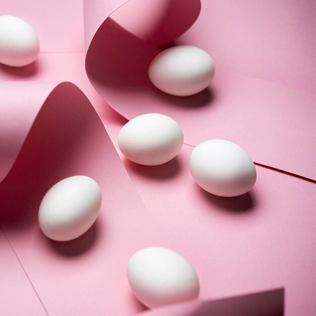 White eggs on pink background