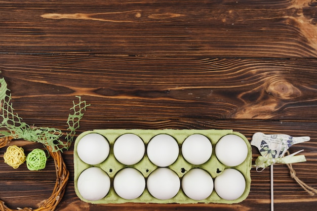 White eggs in rack on wooden table