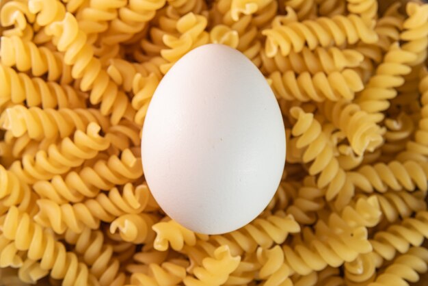 White eggs on the raw pasta