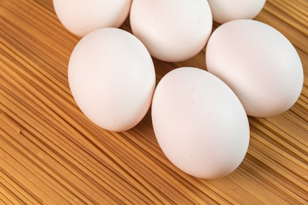 Free photo white eggs on the raw pasta