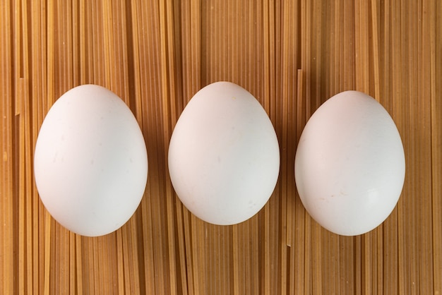 White eggs on the raw pasta