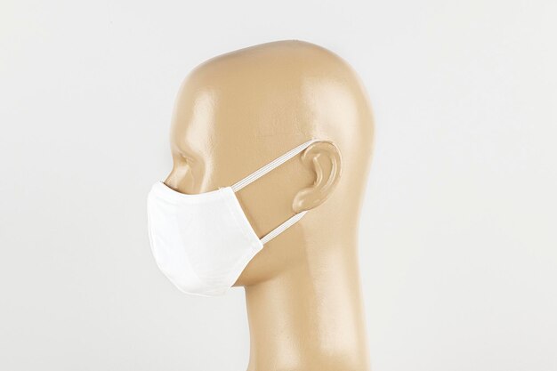 White fabric face mask on a mannequin