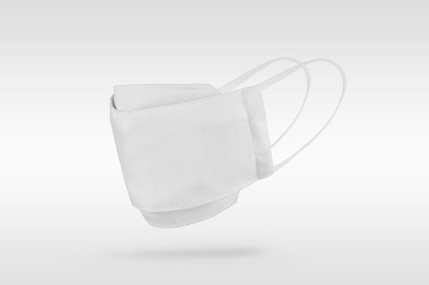 White fabric face mask on off white background