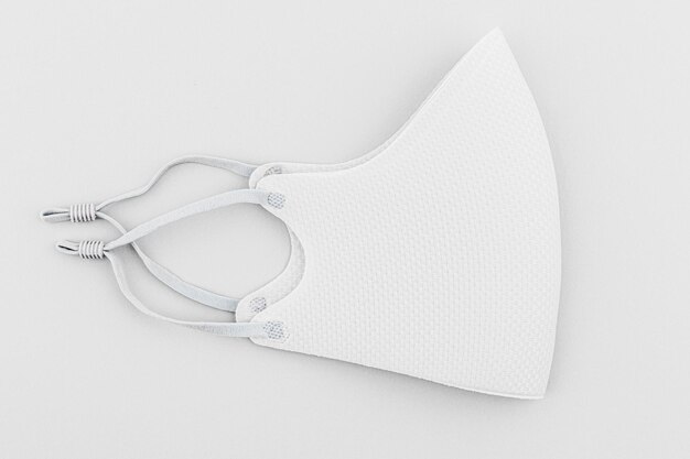 White fabric face mask on off white background