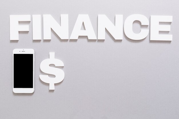 White finance word with dollar sign and smartphone on gray background