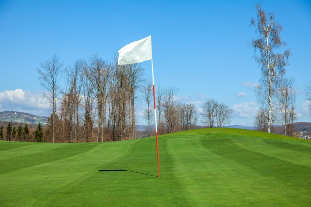 White flag in the center of a golf course in Otocec, Slovenia