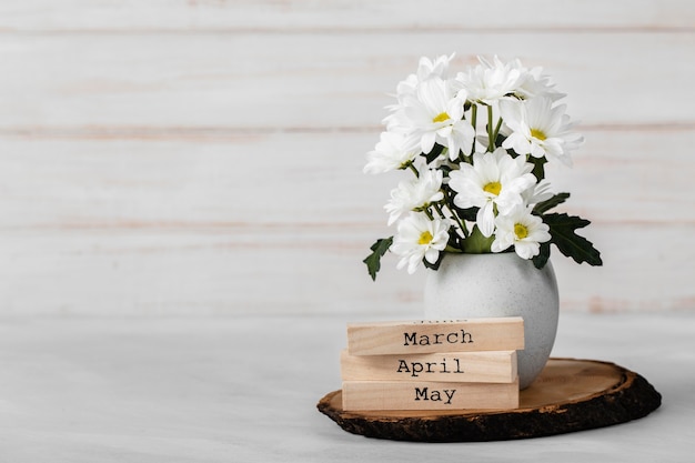 Free photo white flowers assortment in white vase with copy space