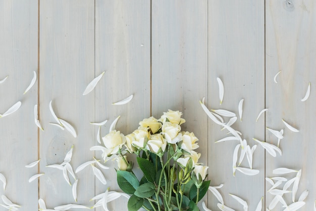 Free photo white flowers on grey wooden desk