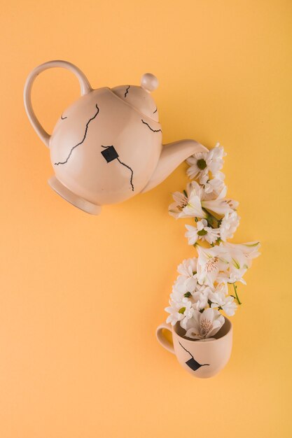 White flowers pouring into cup