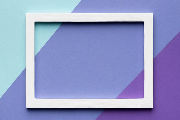 White frame on colorful background flat lay