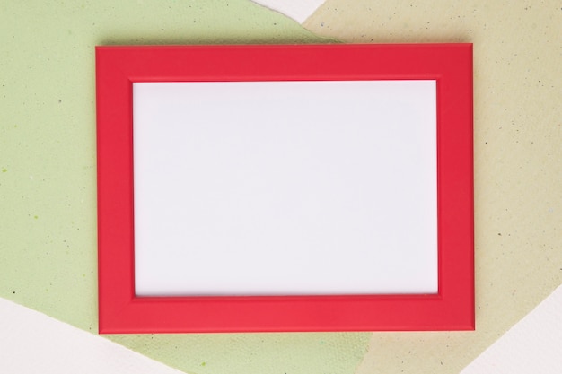 White frame with red border on paper background