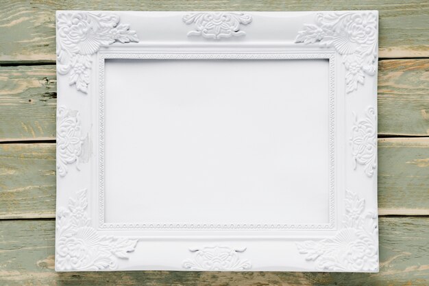 White frame on wooden background