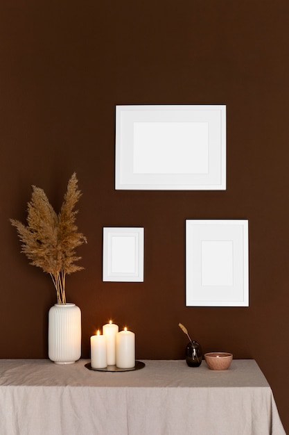 Free photo white frames and lit candles arrangement