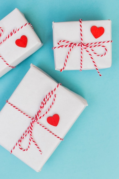 Free photo white gift boxes with hearts on table