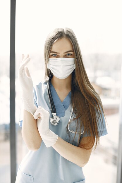 White gloves. Female doctor. Woman by window