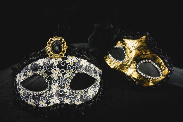 White and golden mask on a dark background