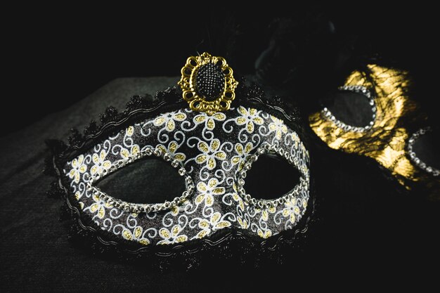 White and golden mask on a dark background